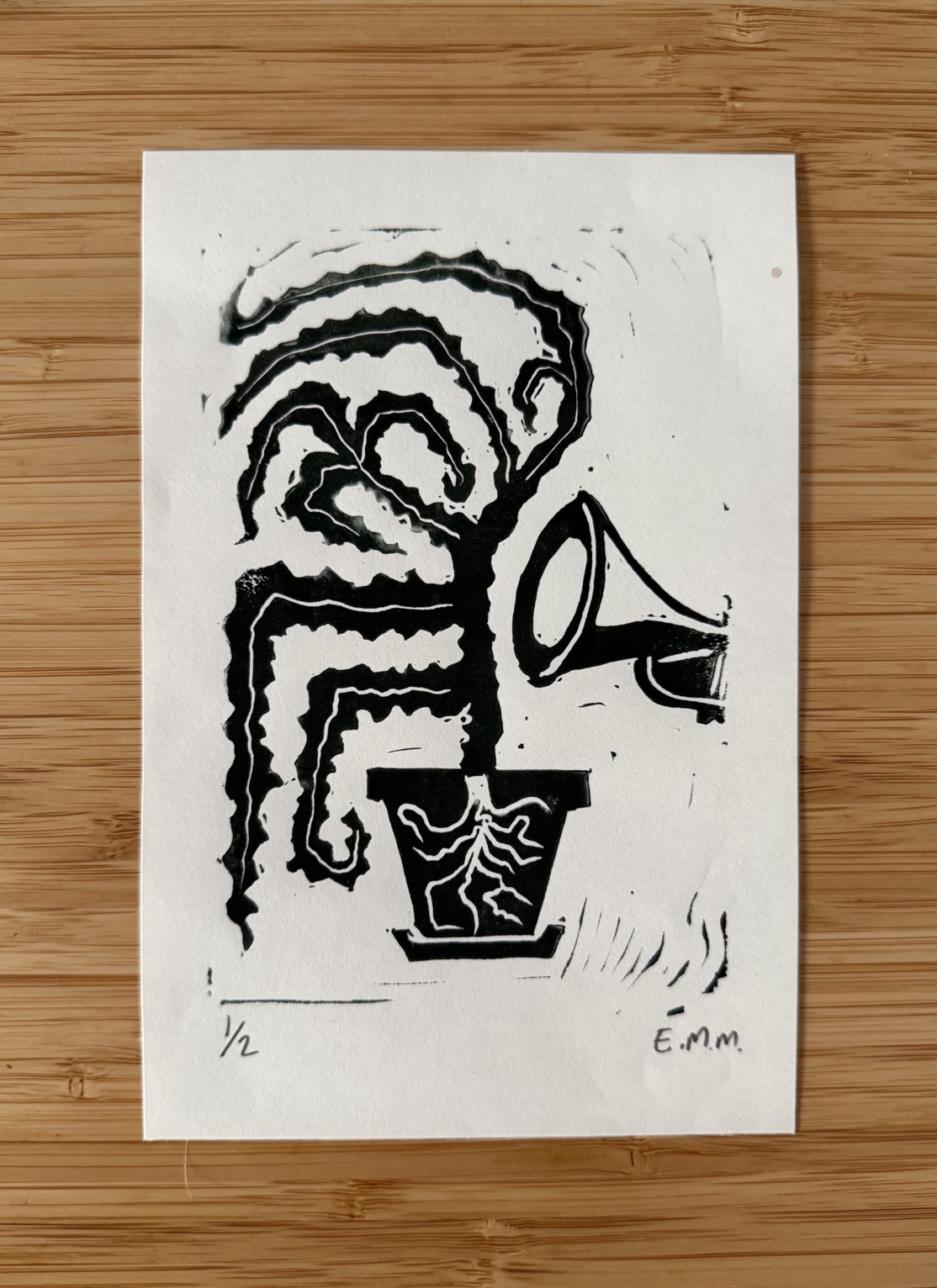Linocut of a trumpet and plant by E.M. Merricks